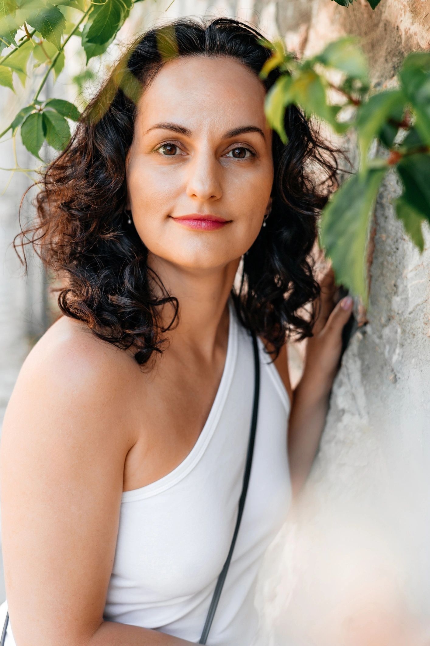 Soft portrait of a woman outdoors with a calm smile